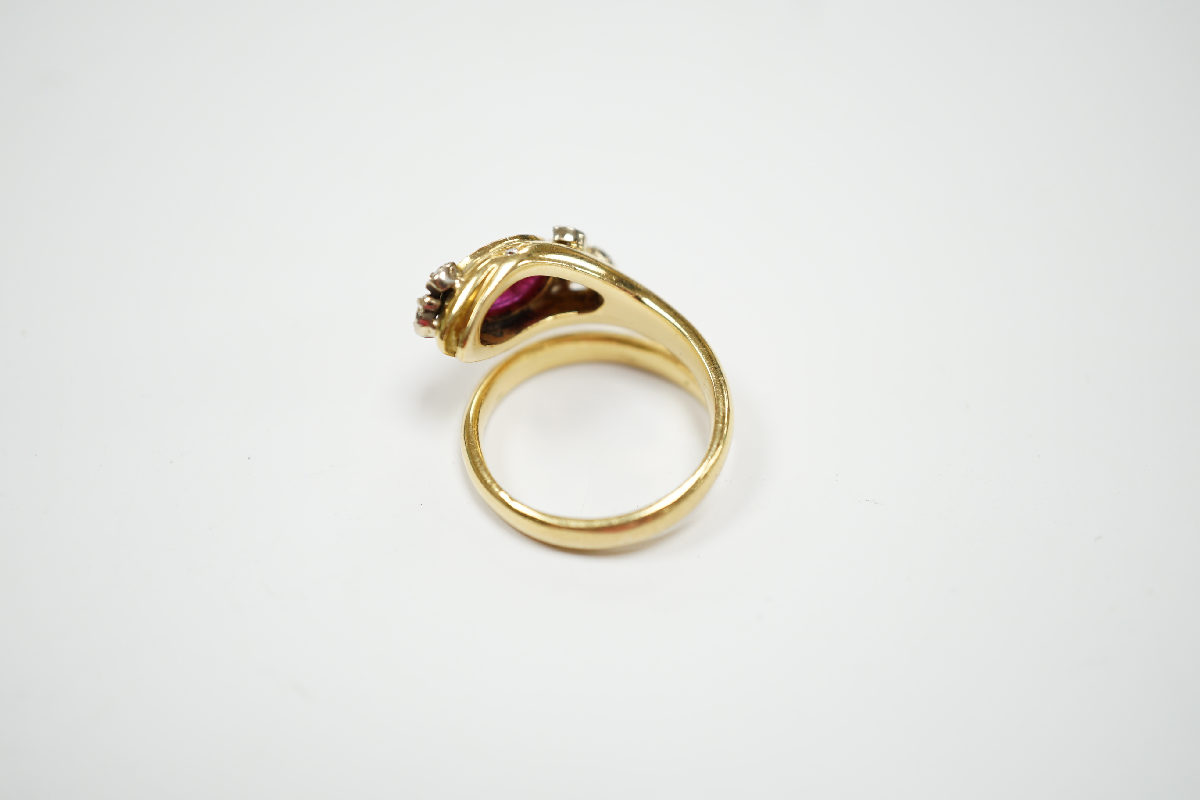 A modern Italian 750, synthetic cabochon ruby and diamond chip set coil shank dress ring, size J/K, gross weight 6.9 grams.